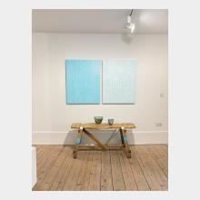 pair of paintings white and blue and blue and white many lines