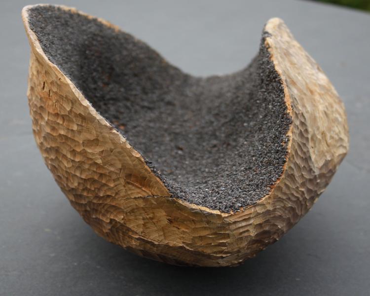 carved wooden sculpture with magnetite